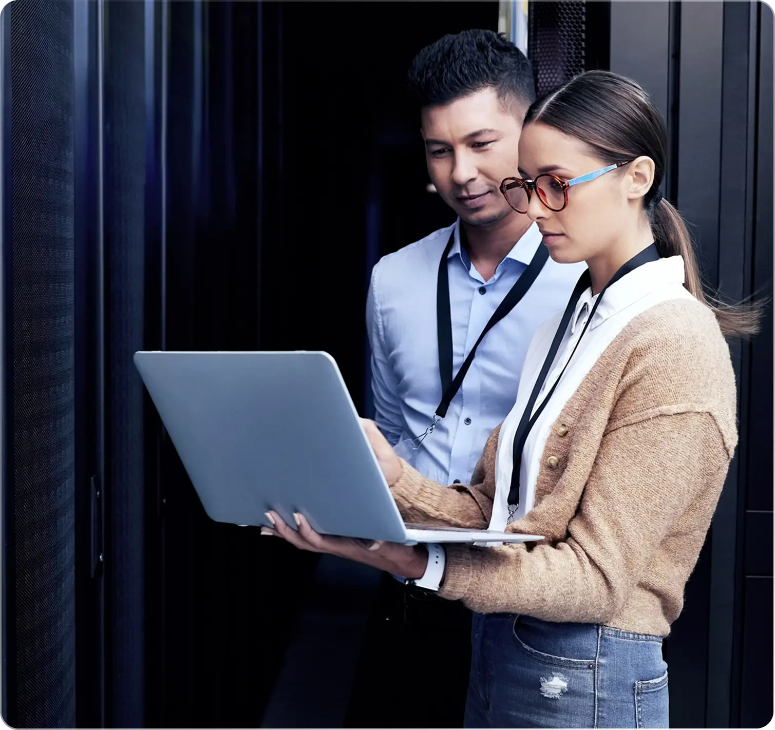 Two people working on a laptop together.